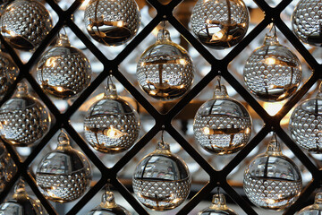 glass transparent balls hanging in metal lattice diamonds, ornamental decoration