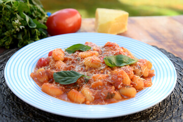 Gnocchi with red Bolognese sauce, typical Italian pasta potato food
