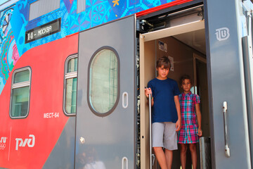  Brother and sister stand in High speed two-storied train and look outside