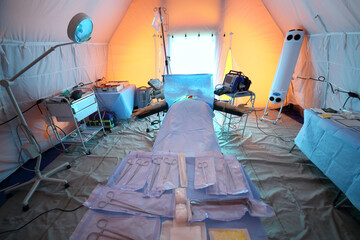 Inside the operating room with a waxwork on the operating table and tools in a field hospital