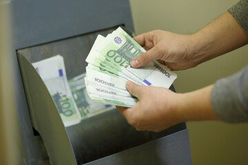 A man holds a fake banknotes to refuse chutes