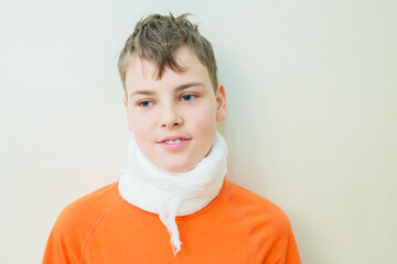 Young boy with neck brace, used for pain in neck, limited range of motion
