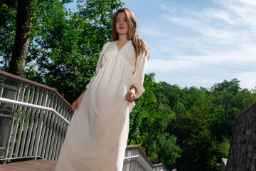 Full-length photo of a beautiful girl. A modern girl in a white romantic dress