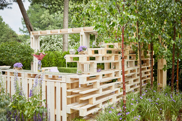 Wooden alcove made of pallets outdoor in summer park