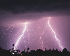 Naklejka na ściany i meble Photo of lightning and storm against the background of the night sky. Long exposure photo. 4K high resolution photo.