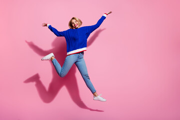 Full body size photo of young energetic funky girlfriend celebrating weekend holidays raised palms up isolated on pink color background
