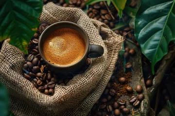 Foto op Plexiglas Cup of coffee with coffee beans in burlap bag and coffee powder in wooden spoon © Vasiliy