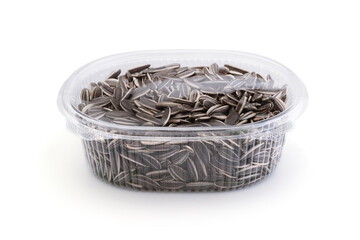 Sunflower seeds in a plastic container isolated.