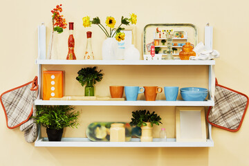 Home-made kitchen shelf with kitchenwear on the wall