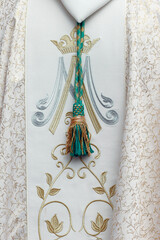 chasuble with the initials of the Virgin Mary.