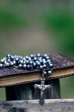 Catholic rosary and bible. Crucifix with Jesus. Religious symbol.