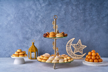 Assorted semolina maamoul or mamoul cookies , awameh or lokma with ramadan decor crescent moon. Traditional arabic Eid al Adha, Eid al Fitr , Ramadan sweets