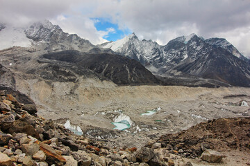 Khumbu glacier originating from Mount Everest forms the headwaters of the Khumbu Khola flowing into the Dudh Kosi - seen here with rock debris and melt pools in May 2017 - obrazy, fototapety, plakaty
