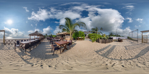 360 hdri panorama with coconut trees on ocean coast near tropical shack or open cafe on beach with swing in equirectangular spherical seamless projection
