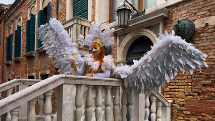 Venice Carnival. People in Venetian carnival masks and costumes on streets of Venice, Italy, Europe...