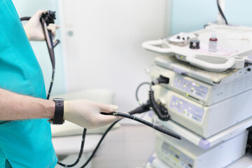Gastroduodenoscopy distal end and manipulator in the hands of doctors in treatment room - obrazy, fototapety, plakaty