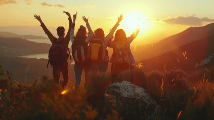 Poster back view group of people spending time together in the mountains and excited making a winner gesture with arms raised over with warm Sunset Light © inthasone