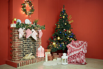 Fototapeta na wymiar Interior of room with firtree decorated to christmas holidays, fireplace, red walls