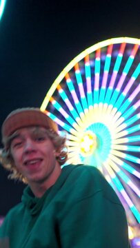 Fashion teen man performing contemporary dance at evening amusement park