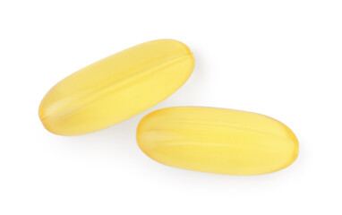 Yellow vitamin capsules isolated on white, top view