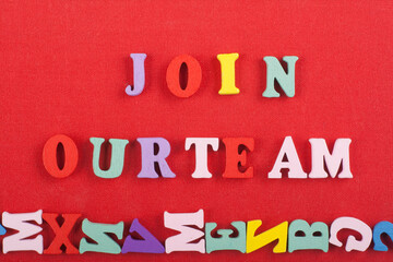 JOIN OUR TEAM word on red background composed from colorful abc alphabet block wooden letters, copy...