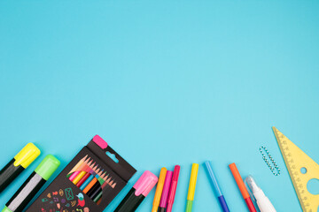 Back to school. Stationery on a blue table. Office desk with copy space. Flat lay.