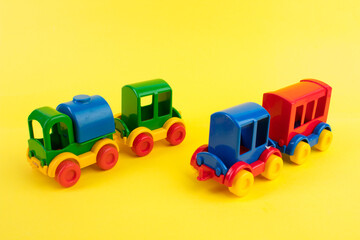Children's toy, a multi-colored steam locomotive on a yellow background.