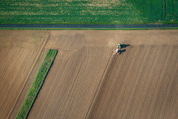 Obraz premium vue aérienne d'un tracteur dans les champs dans les Yvelines en France