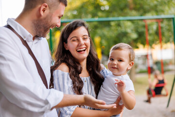 Mother and father spending leisure time outdoors with their child