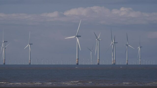 Burbo Bank Offshore Wind Farm seen from crosby beach with clouds in background