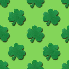 Seamless pattern for St. Patrick's day with clover leaf on green background.