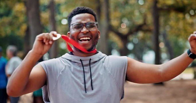 Black man, athlete and celebrate win with medal for success or goal, marathon and long distance running. Sportsman, achievement and victory for track outdoors, pride and fitness for sprinting race.