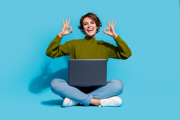 Fototapety  Photo of cheerful glad girl wear stylish clothes sitting floor recommend buy modern device okey sign isolated on cyan color background