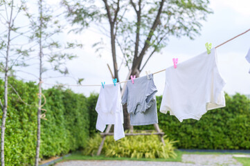 Clothes hanging laundry on washing line for drying against blue sky outdoor