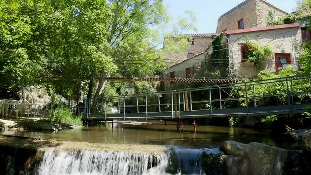 Aerial shot of an operational paper mill in the Black Mountain, north of Carcassonne, in the small village of Brousses et Villaret. Seen from a shaded path alongside a small stream.