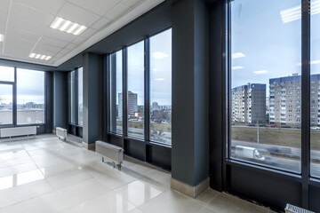 empty hall room with columns, doors and panoramic windows in modern office