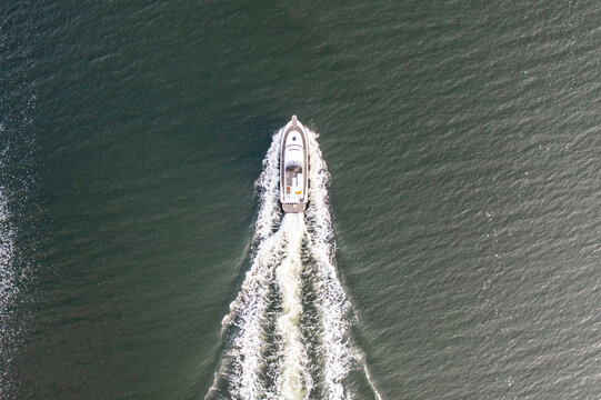 Fishing boat at sea full speed from above