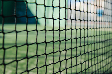 close up of the padel or tennis court net with green background