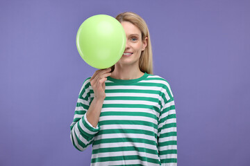 Woman with air balloon on violet background