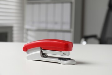 One stapler on white table indoors. Office stationery
