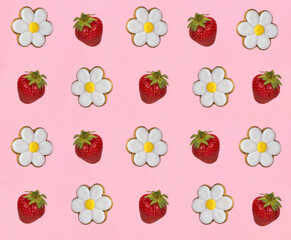 Gingerbread cookies in the shape of chamomile and strawberry on the pink background. Top view. Copy space.