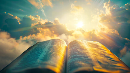 A serene image of an open Bible set against a backdrop of soft clouds in the sky, evoking calm and reverence - obrazy, fototapety, plakaty