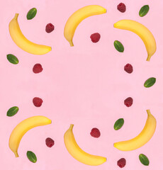 Banana and raspberry on the pink background. Copy space. Top view.