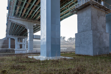 Fototapeta na wymiar steel frame and concrete construction huge car bridge across the wide river