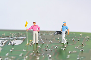 Golfer, athlete on an electronic component, photography of miniature figures