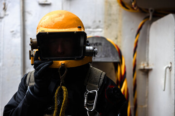 An industrial diver closeup in commercial diving helmet - 751706438