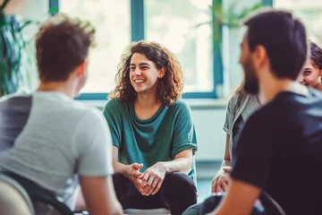  People support each other in a rehab session. People communicating with each other sitting in circle in group therapy session. © VisualProduction