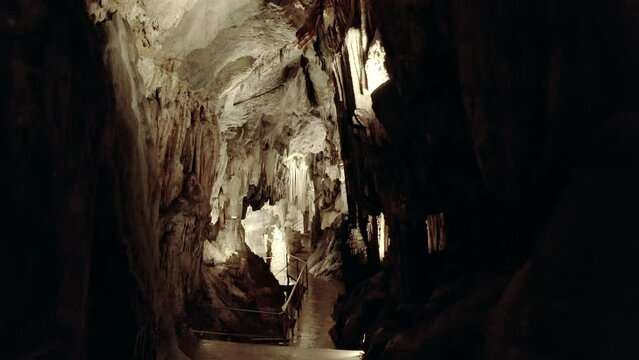 Forward tracking shot of the giant chasm of Cabrespine in southern France. Cinematic shot of a big cave.