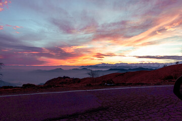 Sunset in the mountains. Orange sky and indigo shades. Suggestive sunset from Mottarone mountain,...