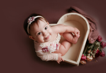 adorable baby posing with heart